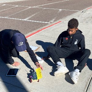 Students using solar cars.